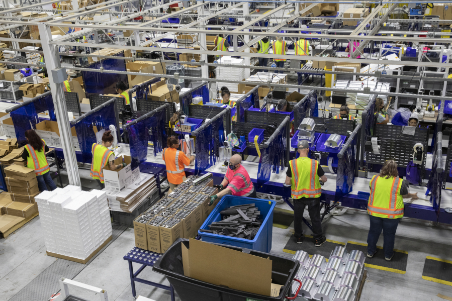 Workers assemble products and packaging on the manufacturing floor at Hawthorne Gardening Company in Vancouver in 2021.