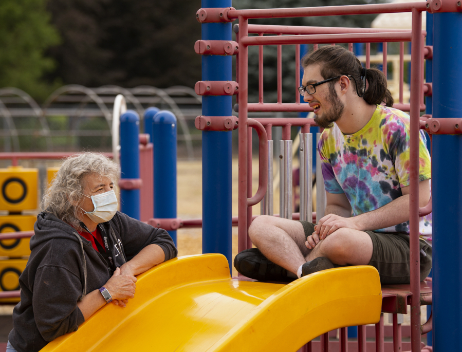 Vancouver Parks and Recreation staff member Karen Miller talks with Hayden Rider, 18, at an Access to Recreation camp at Lieser Elementary School in Vancouver. The camps for individuals with special needs are back on this summer after the pandemic forced a hiatus in 2020.
