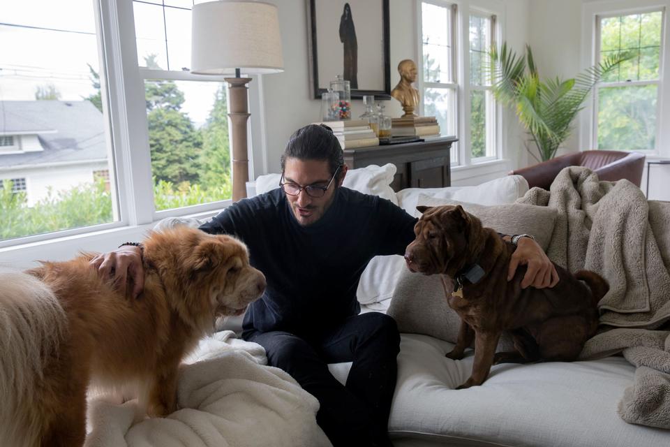 Abraham Dairi spends time with his dogs Ziggy, 3, and Bowie, 4, at his home in Seattle's Montlake neighborhood on July 1, 2021. After the death of his wife, Holly Deierling, in September of 2020, Dairi pushed state lawmakers to provide more resources to people in crisis, including through a bill that will set up a new suicide prevention hotline. (Matt M.