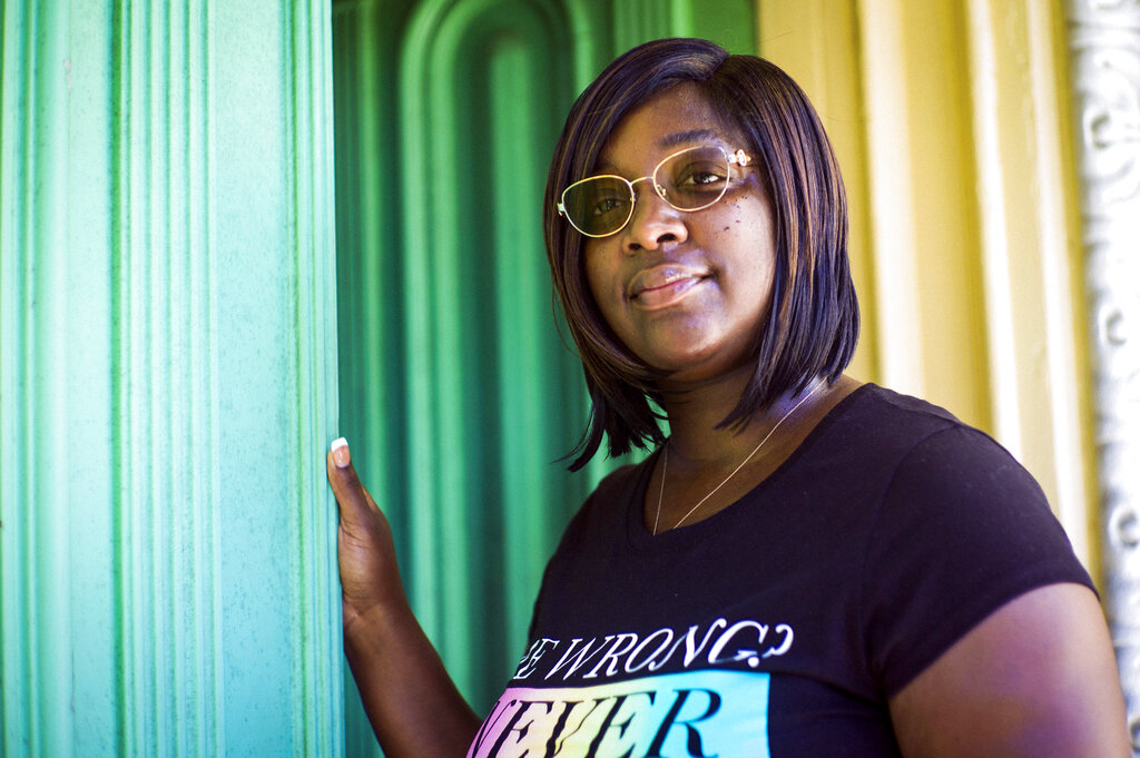 Tamika Daniel poses for a photo in Richmond, Va., Thursday, July 15, 2021. Daniel, a 35-year-old mother of four, will start receiving the Child Tax Credit on Thursday. The extra $1,000 a month for the next year could be a life-changer for Daniel, who now works as a community organizer for a Richmond nonprofit. It will help provide a security deposit on a new apartment. (AP Photo/John C.