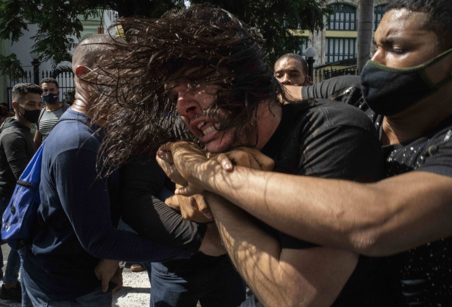 Plainclothes police detain an anti-government protester during a protest in Havana, Cuba, Sunday, July 11, 2021. Hundreds of demonstrators went out to the streets in several cities in Cuba to protest against ongoing food shortages and high prices of foodstuffs, amid the new coronavirus crisis.