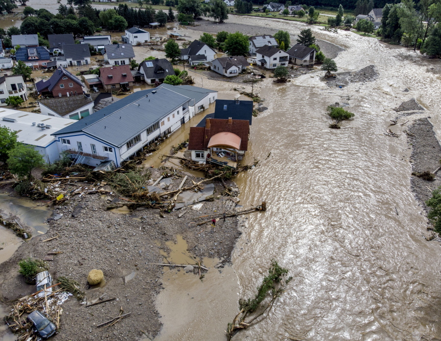 Damaged houses are seen at the Ahr river in Insul, western Germany, Thursday, July 15, 2021. Due to heavy rain falls the Ahr river dramatically went over the banks the evening before. People have died and dozens of people are missing in Germany after heavy flooding turned streams and streets into raging torrents, sweeping away cars and causing some buildings to collapse.