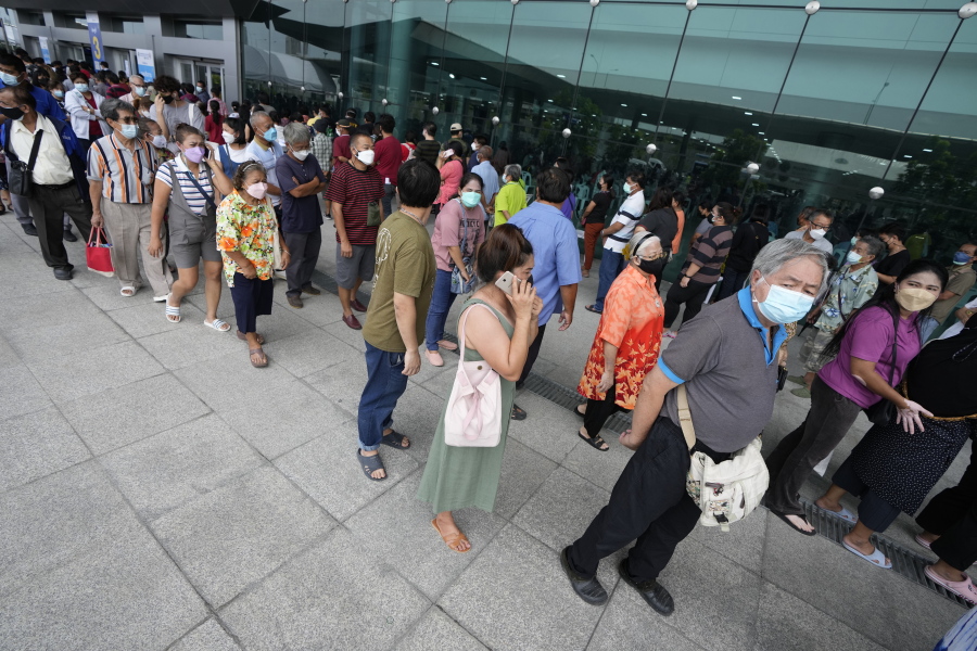 Residents wait on line to receive shots of the AstraZeneca COVID-19 vaccine at the Central Vaccination Center in Bangkok, Thailand, Thursday, July 22, 2021.