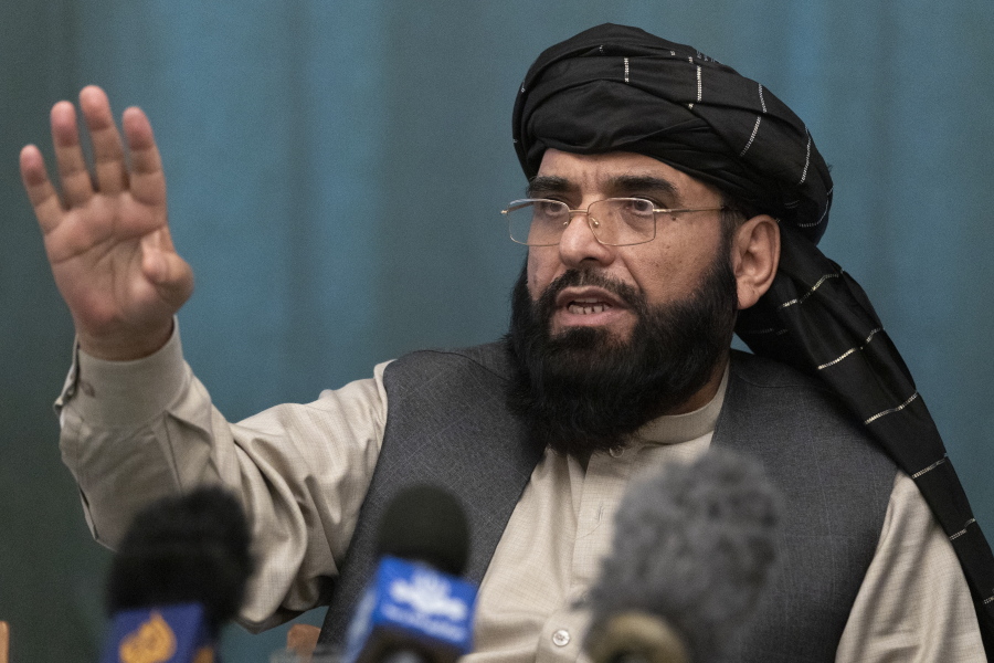 FILE - In this March 19, 2021 file photo, Suhail Shaheen, Afghan Taliban spokesman and a member of the negotiation team gestures while speaking during a joint news conference in Moscow, Russia. In an interview with The Associated Press Thursday, July 22, 2021, Shaheen said the insurgent movement does not want to monopolize power, but there won't be peace until there is a new, negotiated government in Kabul and Afghan President Ashraf Ghani is removed. Shaheen said women will be allowed to work, go to school, and participate in politics but will have to wear the hijab, or headscarf.