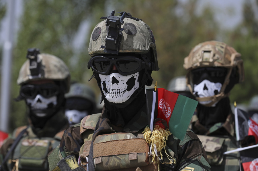 FILE - In this July 17, 2021 file photo, masked Afghan Army Special Forces attend their graduation ceremony after a three-month training program at the Kabul Military Training Center, in Kabul, Afghanistan. The US and NATO have promised to pay $4 billion a year until 2024 to finance Afghanistan's military and security forces, which are struggling to contain an advancing Taliban. Already since 2001, the U.S. has spent nearly $89 billion to build, equip and train the forces.