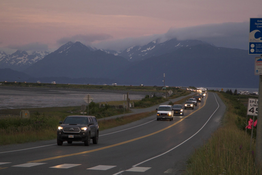 A line of cars evacuates the Homer Spit in Homer, Alaska on July 28, 2021, after a tsunami warning was issued following a magnitude 8.2 earthquake. The tsunami warning for much of Alaska's southern coast was canceled when the biggest wave, of just over a half foot, was recorded in Old Harbor. Alaska.
