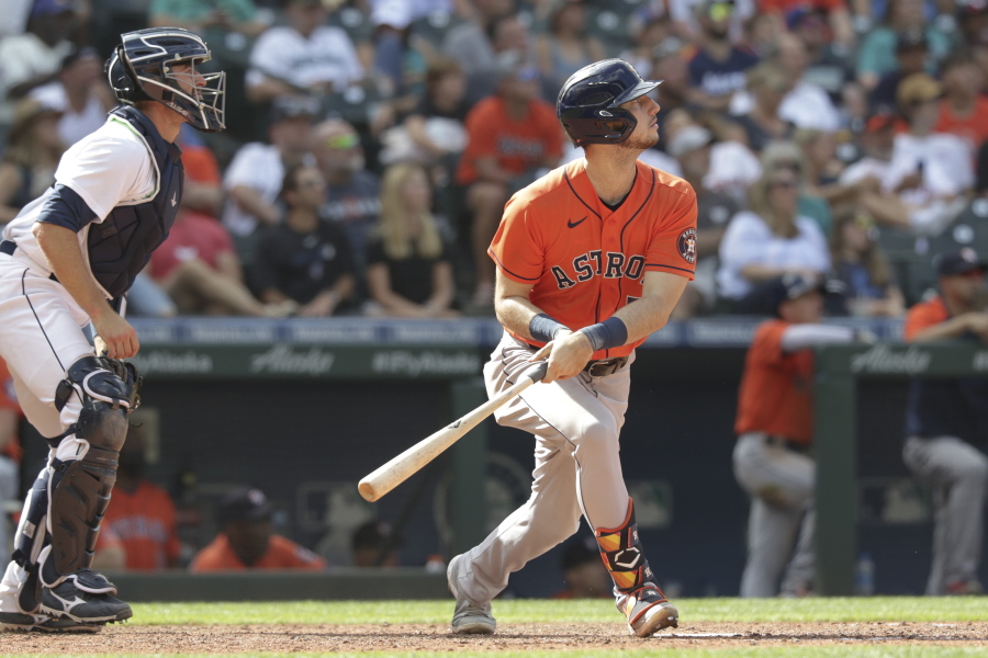 Houston Astros' Kyle Tucker watches his two-run home run, next to Seattle Mariners catcher Tom Murphy, during the eighth inning of a baseball game Wednesday, July 28, 2021, in Seattle.