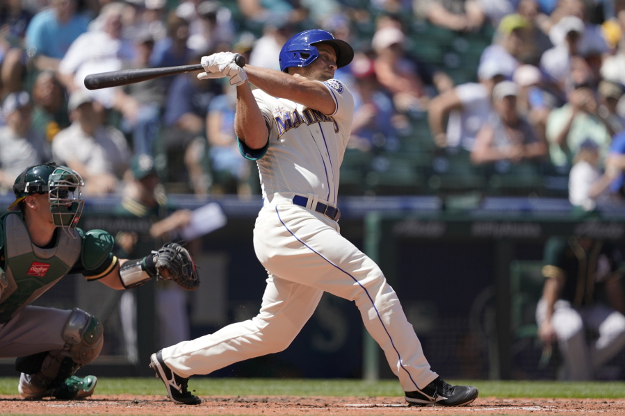 Seattle Mariners' Kyle Seager hits a two-RBI single against the Oakland Athletics during the third inning of a baseball game, Sunday, July 25, 2021, in Seattle. (AP Photo/Ted S.