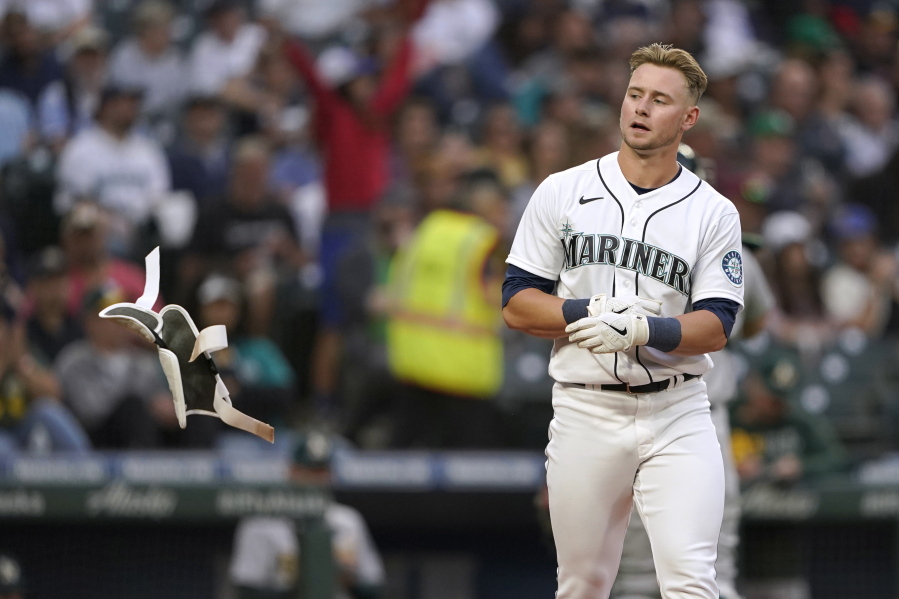 Seattle Mariners' Jarred Kelenic tosses his batting pad after striking out to end the fourth inning of the team's baseball game against the Oakland Athletics, Thursday, July 22, 2021, in Seattle. (AP Photo/Ted S.