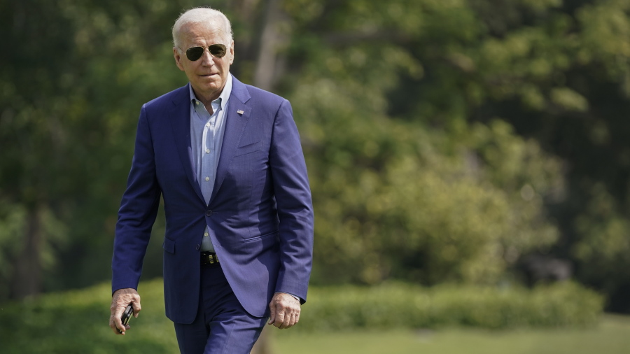 President Joe Biden walks on the South Lawn of the White House after stepping off Marine One, Sunday, July 25, 2021, in Washington. Biden is returning to Washington after spending the weekend in Delaware.