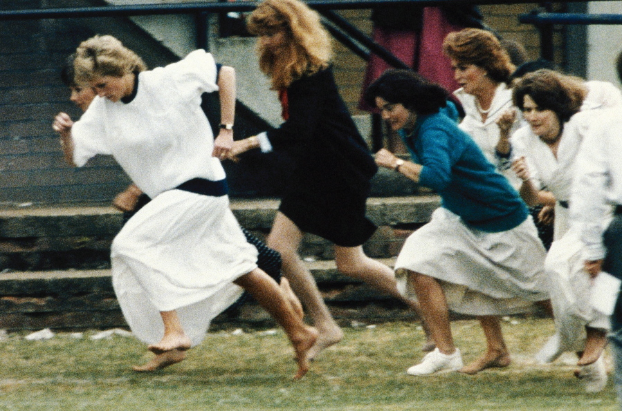 FILE - In this file photo dated Tuesday, June 28, 1989, Britain's Princess Diana wearing a white dress, races ahead during the mother's race, held during a sports day for Wetherby school, where her son Prince William is a pupil. T For someone who began her life in the spotlight as "Shy Di," Princess Diana became an unlikely, revolutionary during her years in the House of Windsor. She helped modernize the monarchy by making it more personal, changing the way the royal family related to people. By interacting more intimately with the public -- kneeling to the level of children, sitting on edge of a patient's hospital bed, writing personal notes to her fans -- she set an example that has been followed by other royals as the monarchy worked to become more human and remain relevant in the 21st century.