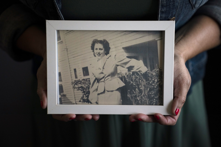 Stacy Cordova, whose aunt was a victim of California's forced sterilization program that began in 1909, holds a framed photo of her aunt Mary Franco, Monday, July 5, 2021, in Azusa, Calif. Franco was sterilized when she was 13 in 1934. Franco has since died, but Cordova has been advocating for reparations on her behalf. (AP Photo/Jae C.