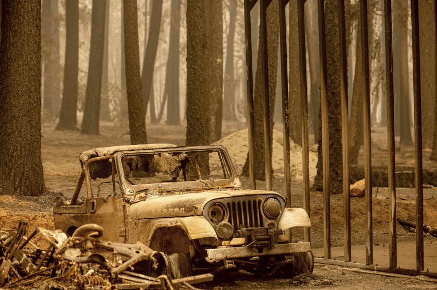 Following the Dixie Fire, a scorched Jeep rests in the Indian Falls community of Plumas County, Calif., on Monday, July 26, 2021.