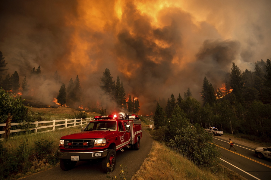 Firefighters battle the Tamarack Fire in the Markleeville community of Alpine County, Calif., on Saturday, July 17, 2021.