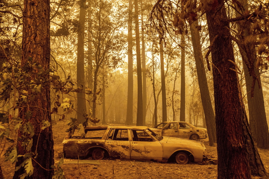 Following the Dixie Fire, scorched cars are seen in a clearing in the Indian Falls community of Plumas County, Calif., on Sunday, July 25, 2021.