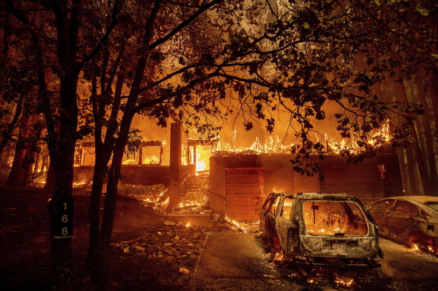 Flames consume a home as the Dixie Fire tears through the Indian Falls community in Plumas County, Calif., Saturday, July 24, 2021. The fire destroyed multiple residences in the area.