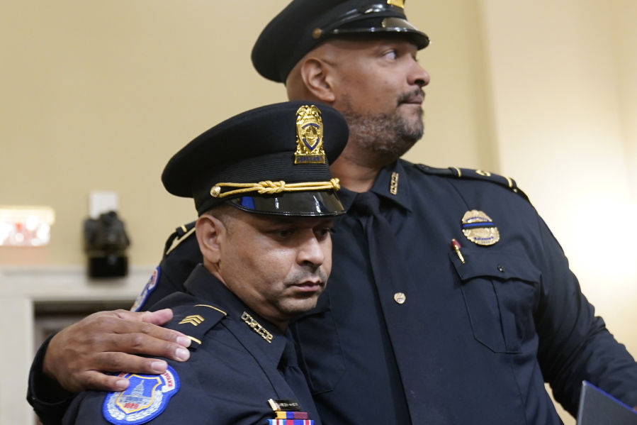 U.S. Capitol Police Sgt. Aquilino Gonell left, and U.S. Capitol Police Sgt. Harry Dunn stand after the House select committee hearing on the Jan. 6 attack on Capitol Hill in Washington, Tuesday, July 27, 2021.