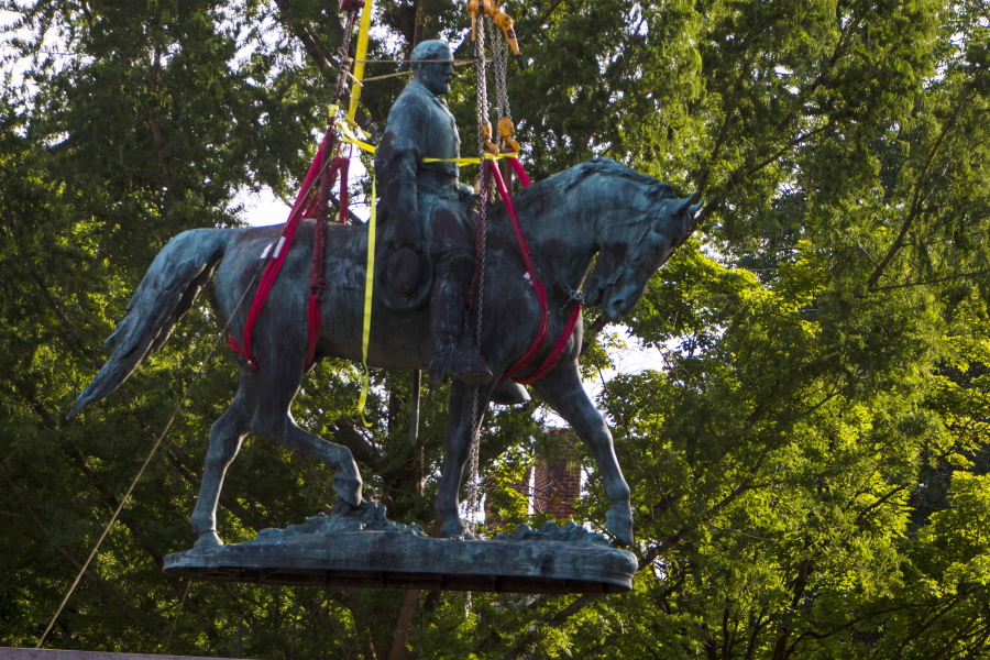 Workers remove the monument of Confederate General Robert E. Lee on Saturday, July 10, 2021 in Charlottesville, Va.   The removal of the Lee statue follows years of contention, community anguish and legal fights. (AP Photo/John C.