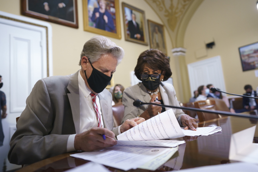 House Energy and Commerce Chairman Frank Pallone, D-N.J., left, and House Financial Services Committee Chairwoman Maxine Waters, D-Calif., go over their notes at the House Rules Committee as they prepare an emergency extension of the eviction moratorium, at the Capitol in Washington, Friday, July 30, 2021. President Joe Biden called on "Congress to extend the eviction moratorium to protect such vulnerable renters and their families without delay." (AP Photo/J.