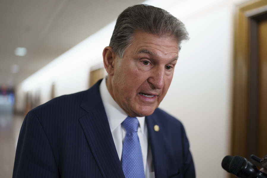 FILE - In this June 23, 2021, file photo Sen. Joe Manchin, D-W.Va., chairman of the Senate Energy and Natural Resources Committee, talks to reporters at the Capitol in Washington. Top congressional Democrats are hunting for the sweet spot that would satisfy the party's rival moderate and progressive wings, a crucial moment as they craft legislation financing President Joe Biden's multi-trillion dollar agenda of bolstering the economy and helping families.(AP Photo/J.