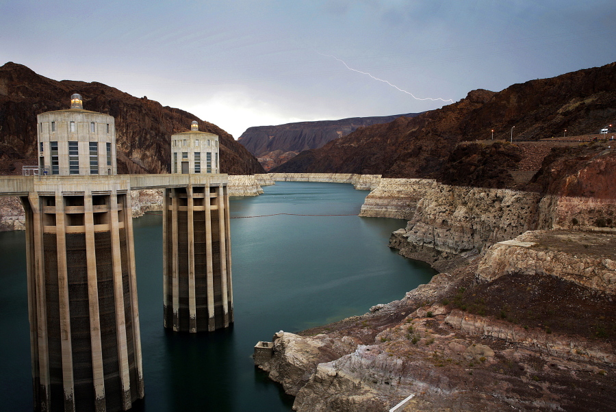 In this July 28, 2014, file photo, lightning strikes over Lake Mead near Hoover Dam that impounds Colorado River water at the Lake Mead National Recreation Area in Arizona. Lawmakers in Congress have introduced a bill that would pump tens of billions of dollars into fixing and upgrading the country's dams. The bill, introduced by Democratic U.S. Rep.