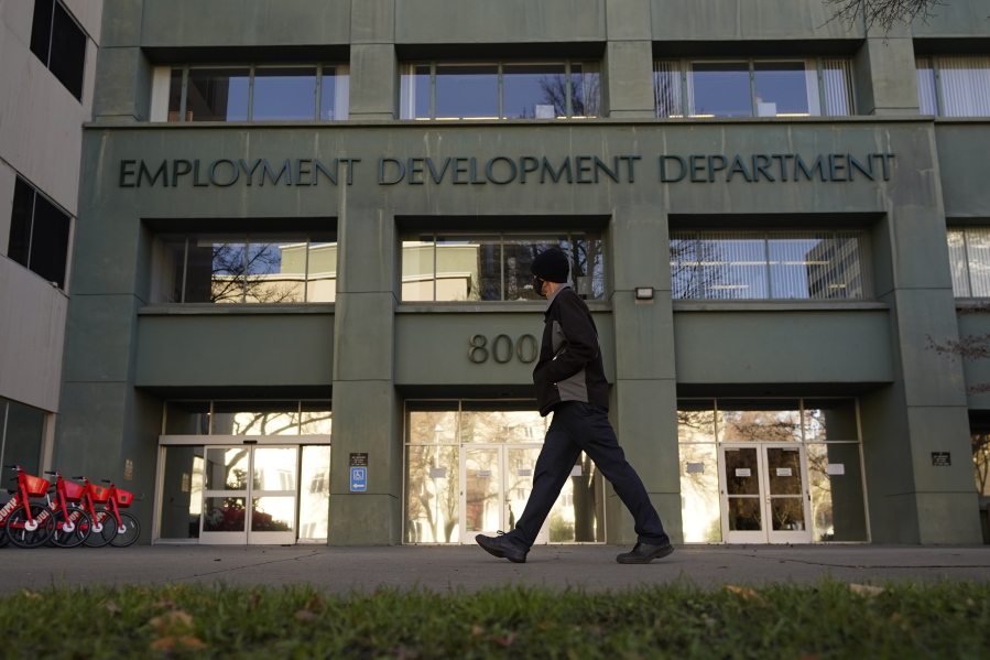 FILE - In this Dec. 18, 2020, file photo, a person passes the office of the California Employment Development Department in Sacramento, Calif. The recession that broke out with onset of the coronavirus pandemic officially ended in April 2021, making it the shortest downturn on record, according to the committee of economists that determines when recessions begin and end.