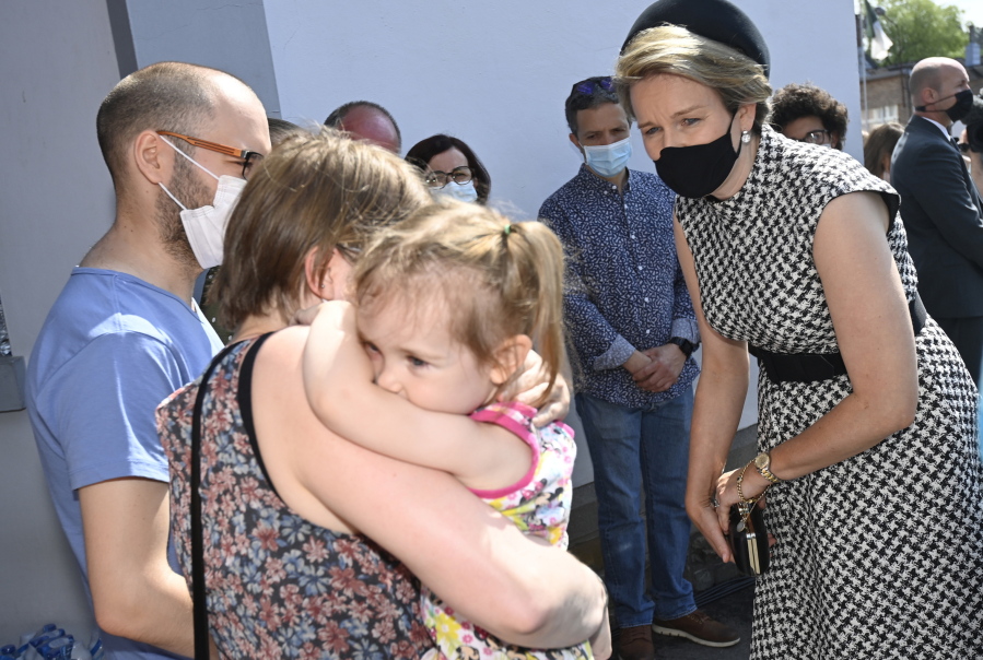 Belgium's Queen Mathilde, right, speaks with residents affected by the floods, prior to participating in a ceremony of one minute of silence to pay respect to victims of the recent floods in Belgium, in Verviers, Belgium, Tuesday, July 20, 2021. Belgium is holding a day of mourning on Tuesday to show respect to the victims of the devastating flooding last week, when massive rains turned streets in eastern Europe into deadly torrents of water, mud and flotsam.
