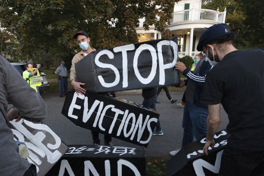 FILE - In this Oct. 14, 2020, file photo, housing activists erect a sign in Swampscott, Mass. A federal freeze on most evictions is set to expire soon. The moratorium, put in place by the Centers for Disease Control and Prevention in September, was the only tool keeping millions of tenants in their homes.