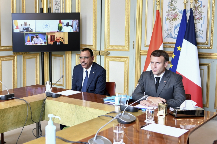 French President Emmanuel Macron and Niger's President Mohamed Bazoum, left, attend a video summit with leaders of G5 Sahel countries after France's decision last month to reduce French anti-terror troops in West Africa, at the Elysee presidential Palace in Paris, Friday July 9, 2021.