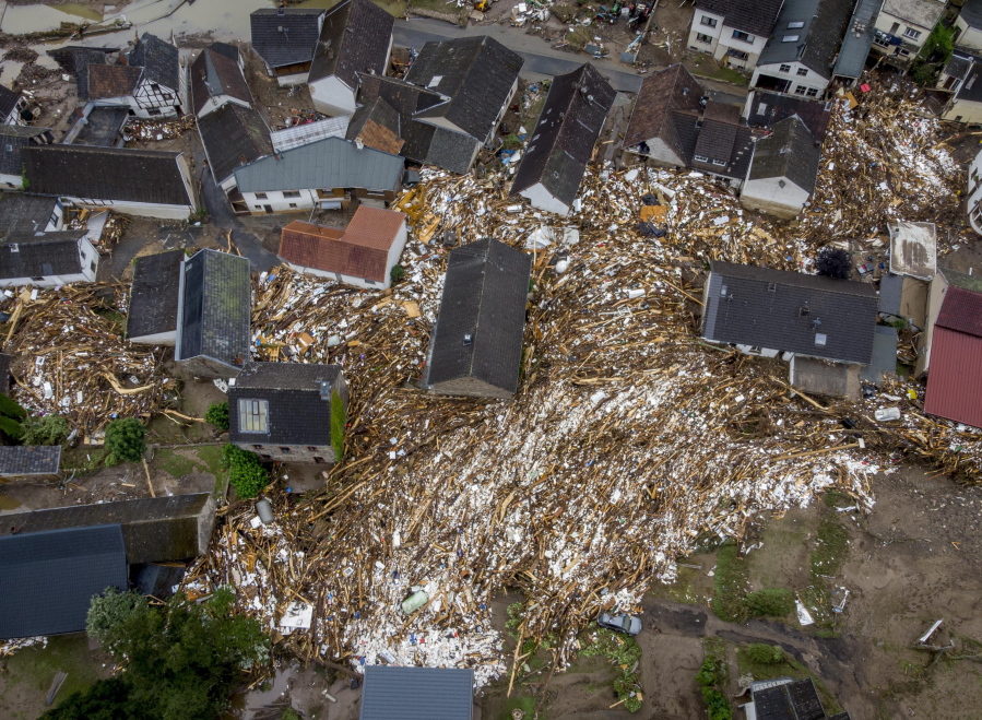 Debris of houses and trees surround houses in Schuld, Germany, Friday, July 16, 2021. Two days before the Ahr river went over the banks after strong rain falls causing severals deaths and hundreds of people missing.