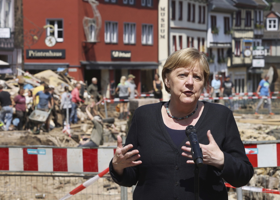 German Chancellor Angela Merkel speaks at a press conference in Muenstereifel, Germany, Tuesday, July 20, 2021. Merkel and North Rhine-Westphalia's Prime Minister Laschet visited Bad Muenstereifel, which was badly affected by the storm.