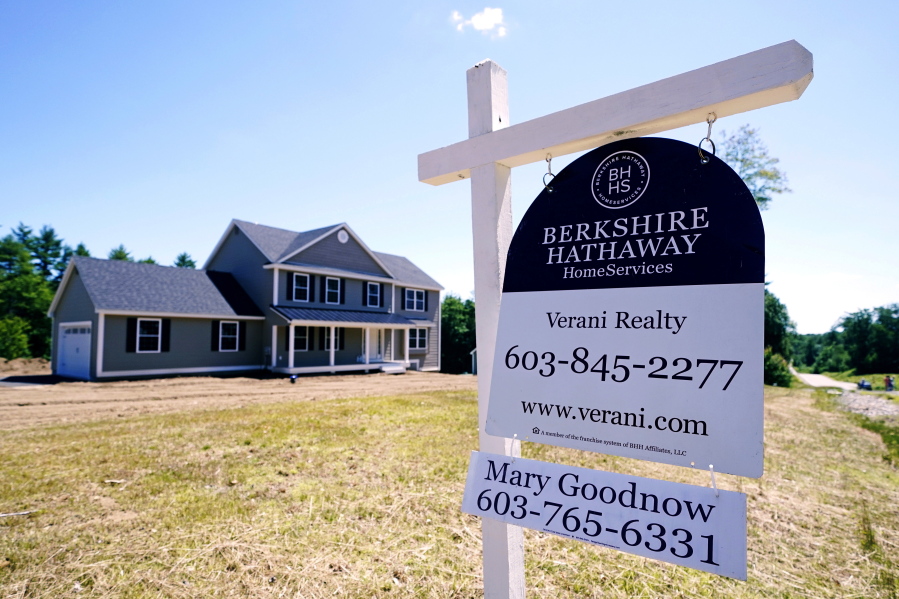 FILE - In this Thursday, June 24, 2021 file photo, a real estate sign is posted in front of a newly constructed single family home in Auburn, N.H. U.S. home prices registered the fastest growth in 17 years in May as a surge in demand for housing outstripped the supply. The S&P CoreLogic Case-Shiller 20-city home price index, released Tuesday, July 27 soared 17% in May from a year earlier on top of a 15% jump in April.