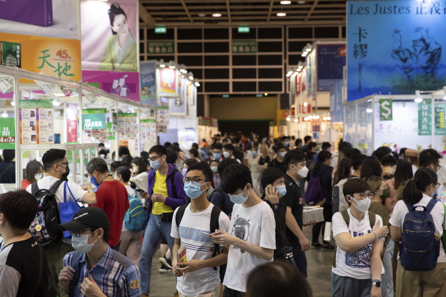 People visit the annual book fair in Hong Kong Wednesday, July 14, 2021. Booksellers at Hong Kong's annual book fair are offering a reduced selection of books deemed politically sensitive, as they try to avoid violating a sweeping national security law imposed on the city last year.