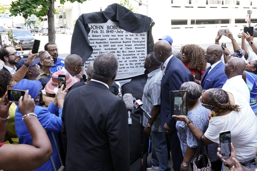 People watch as a new historical marker remembering former Rep. John Lewis is unveiled Friday, July 16, 2021, in Nashville, Tenn. Earlier this year, Nashville's Metro Council renamed a large portion of Fifth Avenue to Rep. John Lewis Way.
