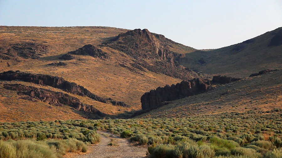 The Montana Mountains loom over Thacker Pass in northern Nevada, July 14, 2021. A federal judge on Friday, July 23, has denied environmentalists' request for a court order temporarily blocking the government from digging trenches for archaeological surveys at a mine planned near the Nevada-Oregon line with the biggest known U.S. deposit of lithium.
