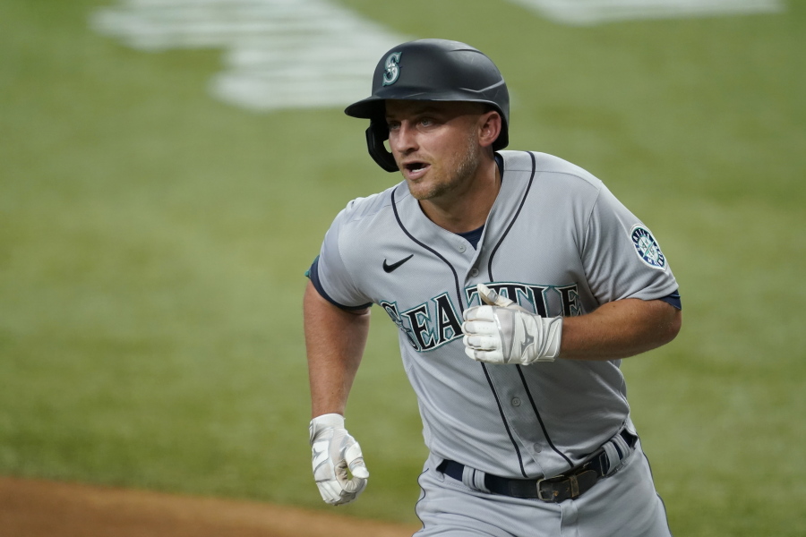 Seattle Mariners' Kyle Seager crosses the plate after hitting a two-run home run during the first inning of the team's baseball game against the Texas Rangers in Arlington, Texas, Saturday, July 31, 2021.