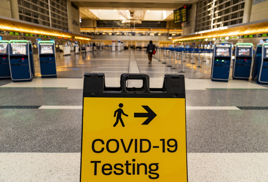 FILE - In this Nov. 25, 2020 file photo, a COVID-19 testing sign is posted at the empty Tom Bradley International Terminal at Los Angeles International Airport.  On Friday, July 30, 2021 The Associated Press reported on stories circulating online incorrectly claiming a table shows a list of planned COVID-19 variants and when they will be "released" to the public.
