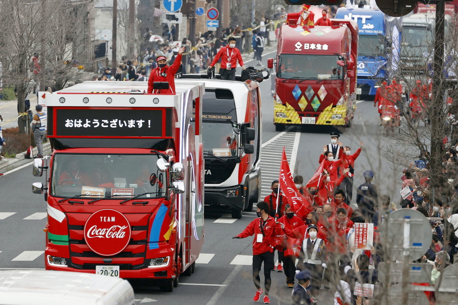 FILE - In this March 28, 2021, file photo, Olympic sponsors' vehicles parade ahead of torch relay in Ashikaga, Tochigi prefecture, north of Tokyo. The Olympic corporate sponsorship program has been a key part of the Olympic experience since it began in 1985. But all that magic from the Olympic sponsorship is being undermined because of the virus.