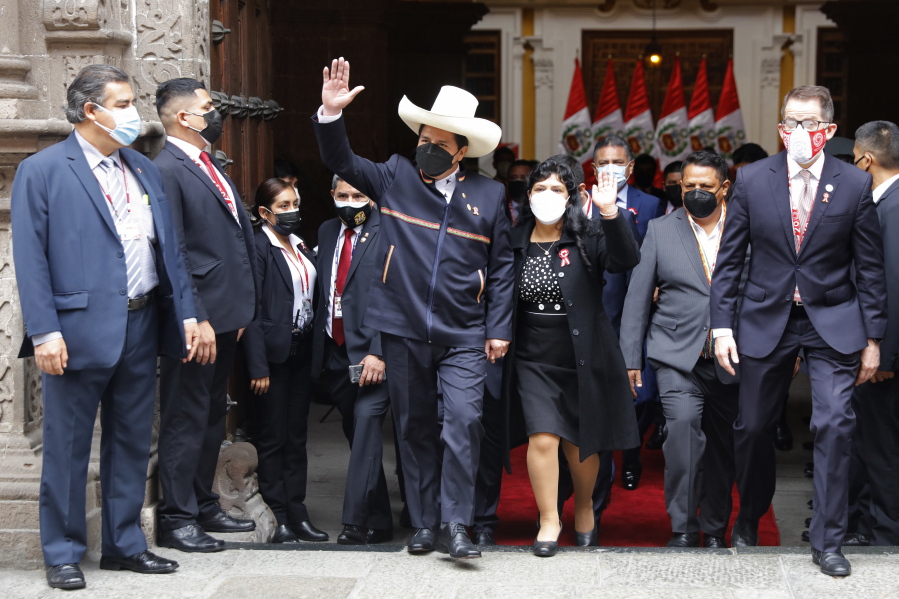 Peru's President-elect Pedro Castillo and his wife Lilia Paredes wave as they leave the Foreign Ministry to go to Congress for his swearing-in ceremony on his Inauguration Day in Lima, Peru, Wednesday, July 28, 2021.