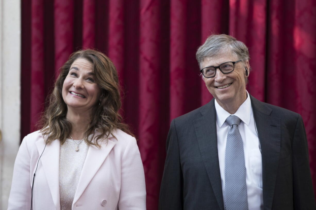 Philanthropist and co-founder of Microsoft Bill Gates and his wife, Melinda, react prior to being awarded the Legion of Honour at the Elysee Palace in Paris in 2017.