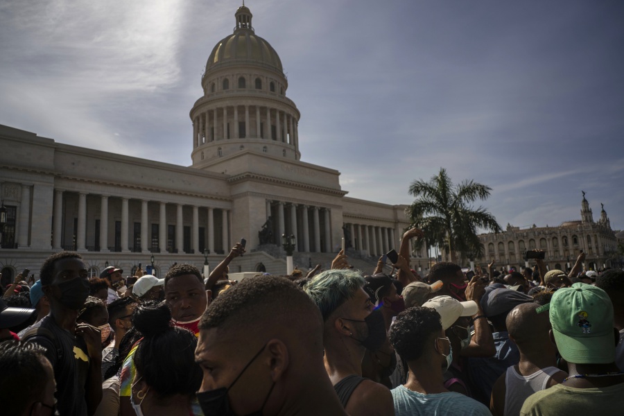 FILE - In this July 11, 2021 file photo, people protest in front of the Capitol in Havana, Cuba. A report released Wednesday, July 21,  shows philanthropic funding to promote global human rights reached a record $3.7 billion in 2018. The report by the philanthropy research organization Candid and Human Rights Funders Network says nearly half of the donations came from 12 foundations and most of the contributions were earmarked for programs in North America.