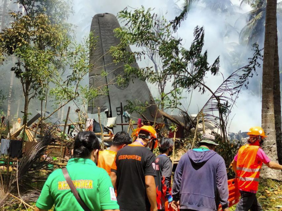 THIS CORRECTS THE NAME OF THE PROVINCE TO SULU, INSTEAD OF JOLO - In this photo released by the Joint Task Force - Sulu, rescuers search for bodies from the site where a Philippine military C-130 plane crashed in Patikul town, Sulu province, southern Philippines on Sunday, July 4, 2021. The Philippine air force C-130 aircraft carrying troops crashed in a southern province after missing the runway Sunday, killing more than a dozen military personnel while at least 40 were rescued from the burning wreckage, officials said.