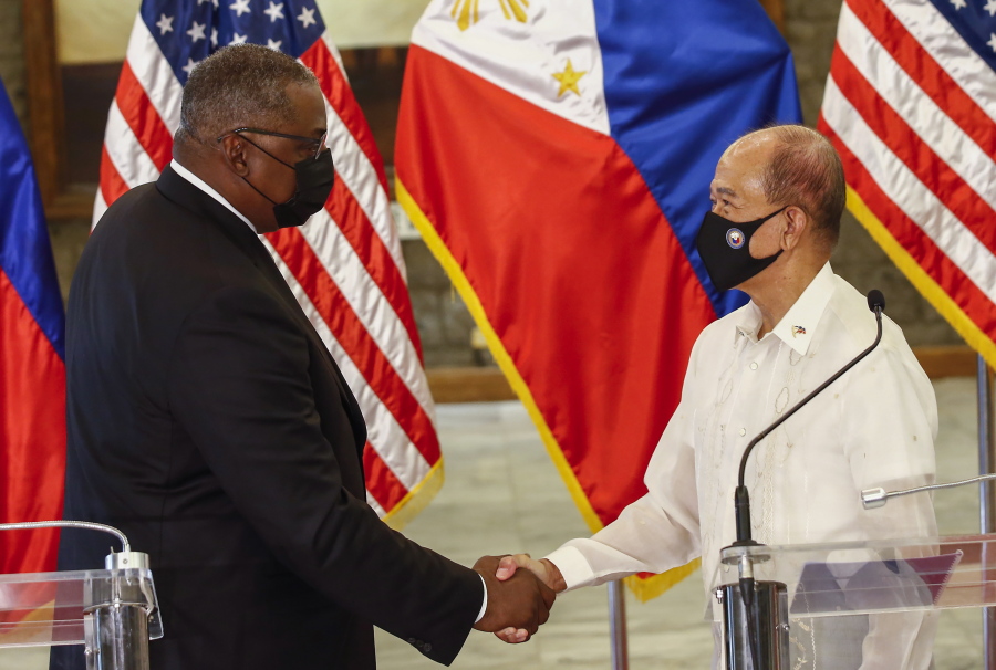 United States Defense Secretary Lloyd Austin, left, and Philippines Defense Secretary Delfin Lorenzana shake hands after a bilateral meeting at Camp Aguinaldo military camp in Quezon City, Metro Manila, Philippines Friday, July 30, 2021. Austin is visiting Manila to hold talks with Philippine officials to boost defense ties and possibly discuss the The Visiting Forces Agreement between the US and Philippines.