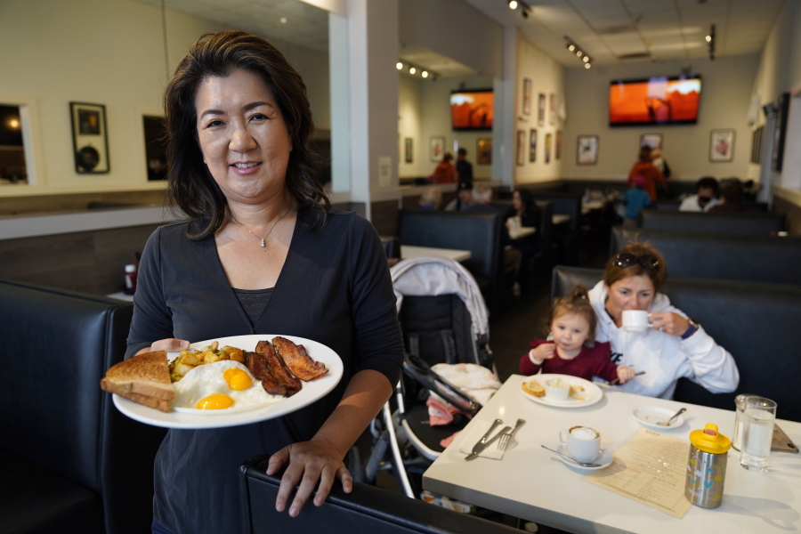 Jeannie Kim holds her popular bacon and eggs breakfast at her restaurant in San Francisco on Friday, July 30, 2021. Thanks to a reworked menu and long hours, Jeannie Kim managed to keep her San Francisco restaurant alive during the coronavirus pandemic. That makes it all the more frustrating that she fears her breakfast-focused diner could be ruined within months by new rules that could make one of her top menu items -- bacon -- hard to get in California.