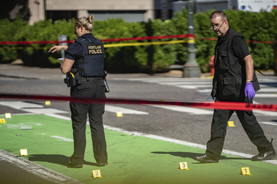 Police investigate an overnight shooting Saturday, July 17, 2021 in Portland, Ore. Police said one person died and at least six people were injured in an early morning shooting Saturday in Portland, Oregon.