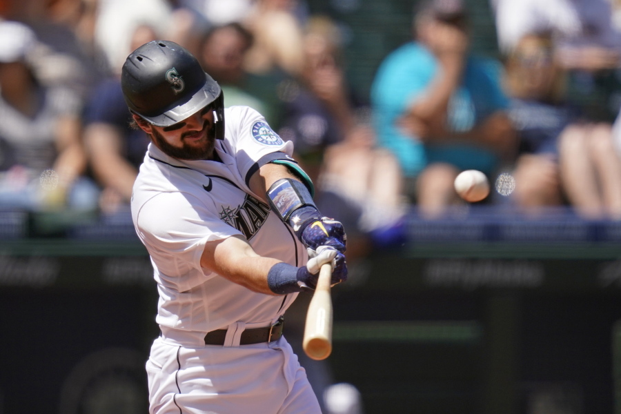 Seattle Mariners' Luis Torrens connects for a three-run home run against the Texas Rangers in the fourth inning of a baseball game Sunday, July 4, 2021, in Seattle.