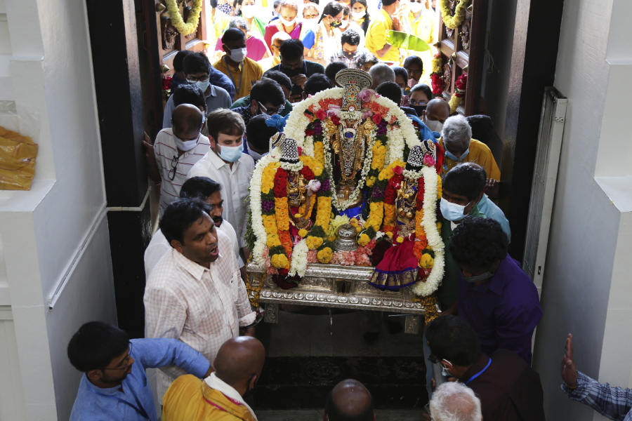 Sri Venkateswara Temple devotees and volunteers carry a deity back into the temple June 27 during Maha Kumbhabhishekam, a five-day Hindu rededication ceremony in Penn Hills, Pa. Built in the 1970s, the Sri Venkateswara Temple is the oldest major Hindu temple in the country.