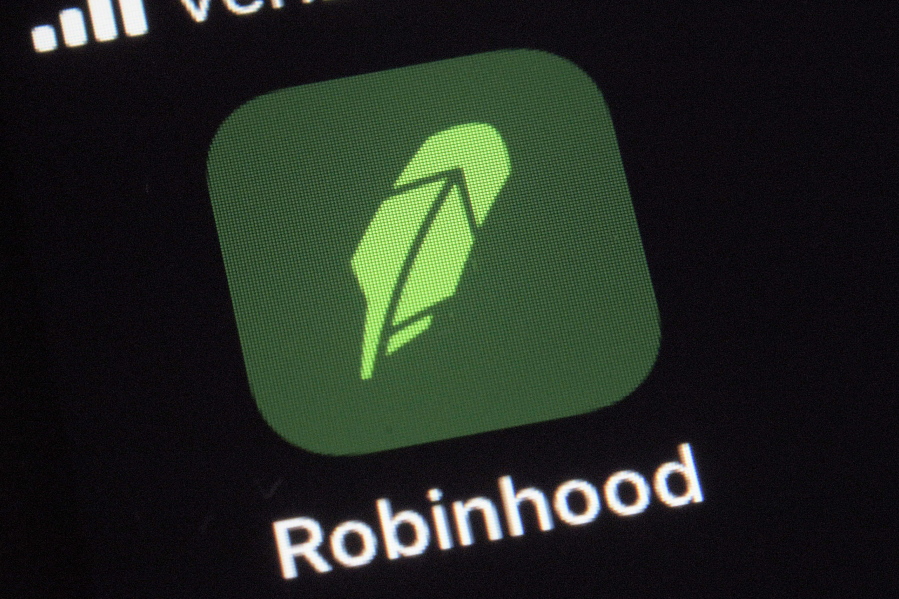 FILE - This Dec. 17, 2020, photo shows the logo for the Robinhood app on a smartphone in New York. After a rocket rise where it introduced millions of people to investing and reshaped the brokerage industry, all while racking up a long list of controversies in less than eight years, Robinhood is about to take the leap itself into the stock market. Robinhood Markets and three of its executives are selling up to 60.5 million shares of its stock in an initial public offering, with trading expected to begin on the Nasdaq Thursday, July 29, 2021.