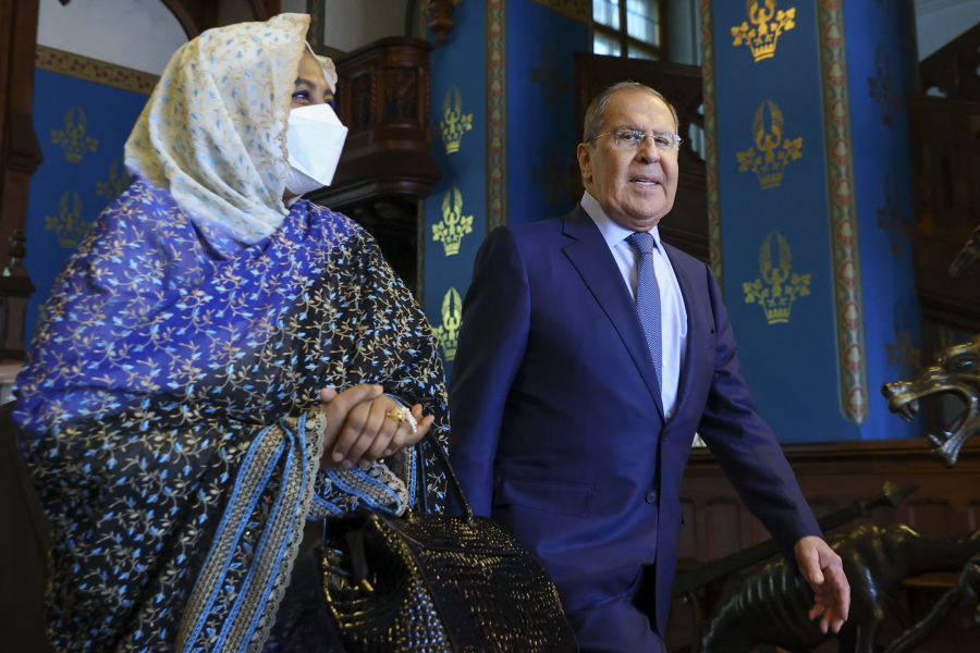 In this photo released by the Russian Foreign Ministry Press Service, Russian Foreign Minister Sergey Lavrov, and Sudanese Foreign Minister Maryam al-Sadiq al-Mahdi arrive to attend talks in Moscow, Russia, Monday, July 12, 2021.