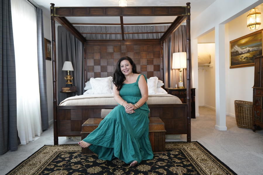 Heather Bise, owner of The House of Bise Bespoke, poses in the "Art" bedroom, Monday, July 19, 2021, in Cleveland. Small businesses in the U.S. that depend on tourism and vacationers say business is bouncing back, as people re-book postponed trips and take advantage of loosening restrictions, a positive sign for the businesses that have struggled for more than a year. Bise started in 2019 and catered to international tourists, attracting guests from New Zealand, Botswana, Eastern Europe and elsewhere.